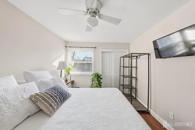 a bedroom with furniture and a flat screen tv