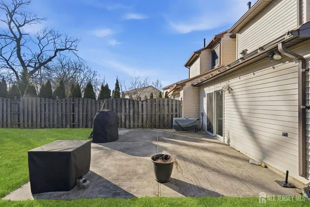 a view of a back yard of the house with a patio