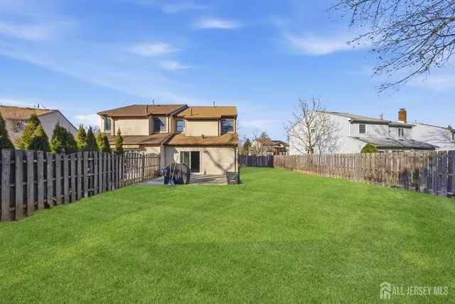 a view of a house with backyard and deck