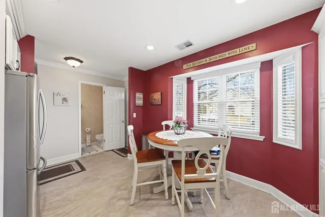 a dining room with furniture and window
