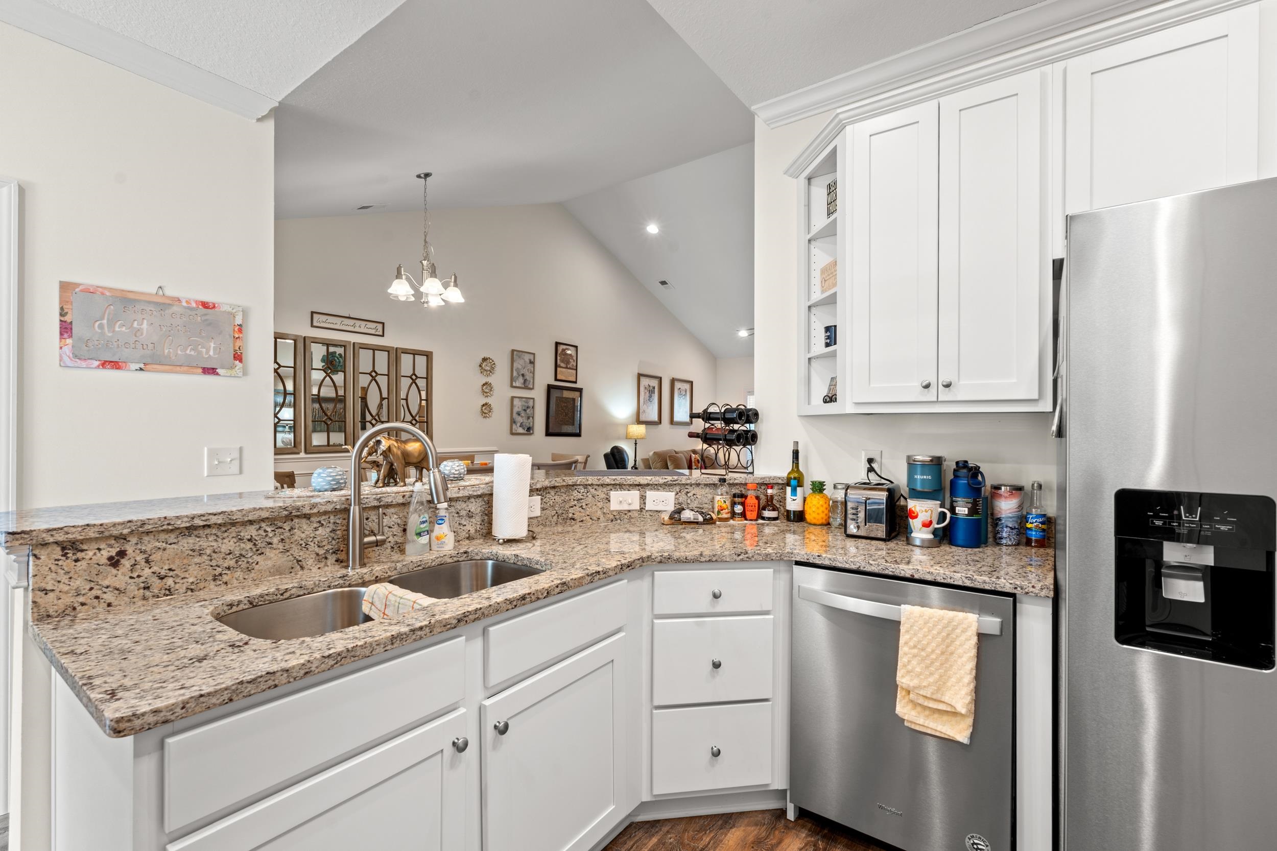 900 Jackline Place, Unit 202 Murrells Inlet, SC 29576 - Photo 17 of 39 Kitchen featuring white cabinets, stainless steel appliances, open shelves, light stone counters, and vaulted ceiling