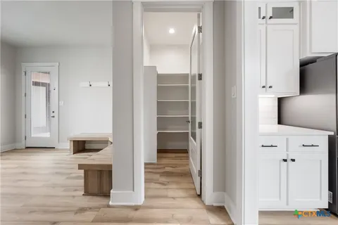 a large bathroom with a granite countertop double vanity sink a mirror and a bathtub