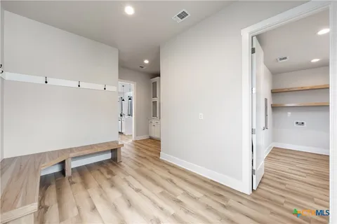a view of entryway with wooden floor and stairs