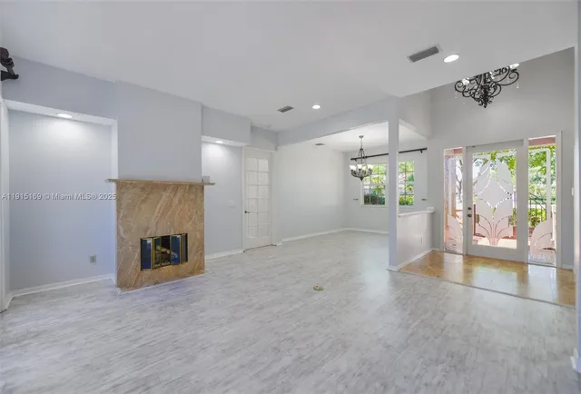 a view of an empty room with a chandelier