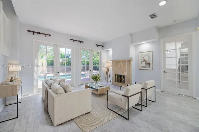 a view of a kitchen island a sink dishwasher a refrigerator and a flat screen tv