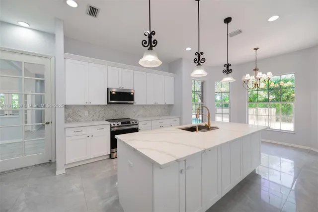 an empty room with a window and a ceiling fan