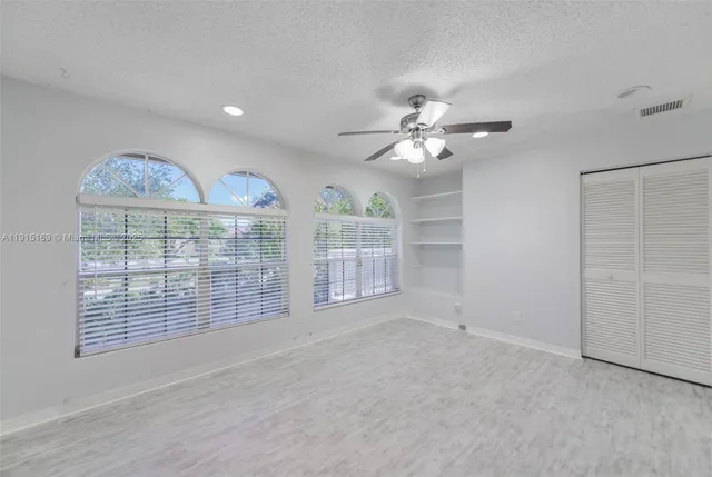 a front view of a house with swimming pool and porch