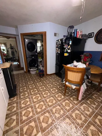 a bedroom with a bed and a mirror on the dresser