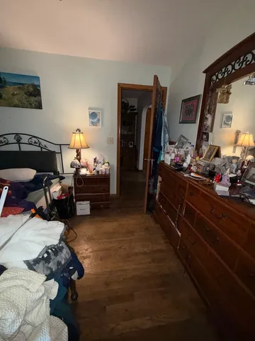 a bedroom with furniture and a flat screen tv