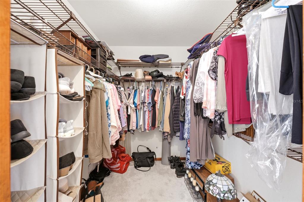 5227 Suwannee Road Weeki Wachee, FL 34607 - Photo 27 of 62 a view of walk in closet with clothes and shoes