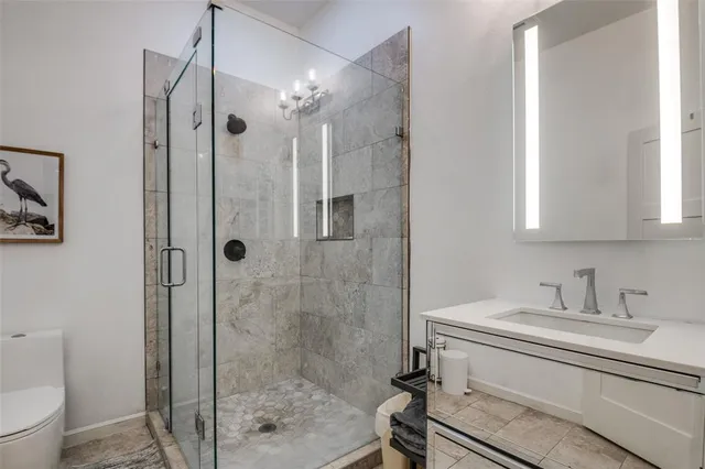 a bathroom with a shower a toilet and a sink