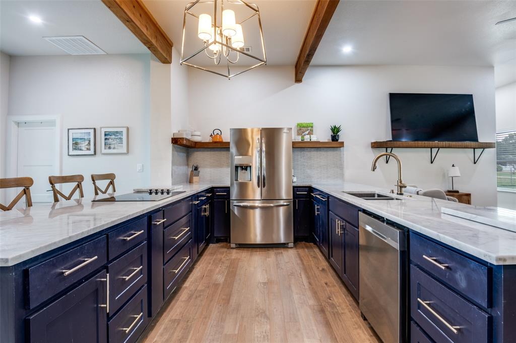 107 Slaughter Ranch Road Trinidad, TX 75163 - Photo 6 of 12 a large kitchen with stainless steel appliances granite countertop a lot of counter space and a sink