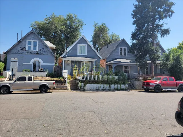 a view of house with outdoor space and parking