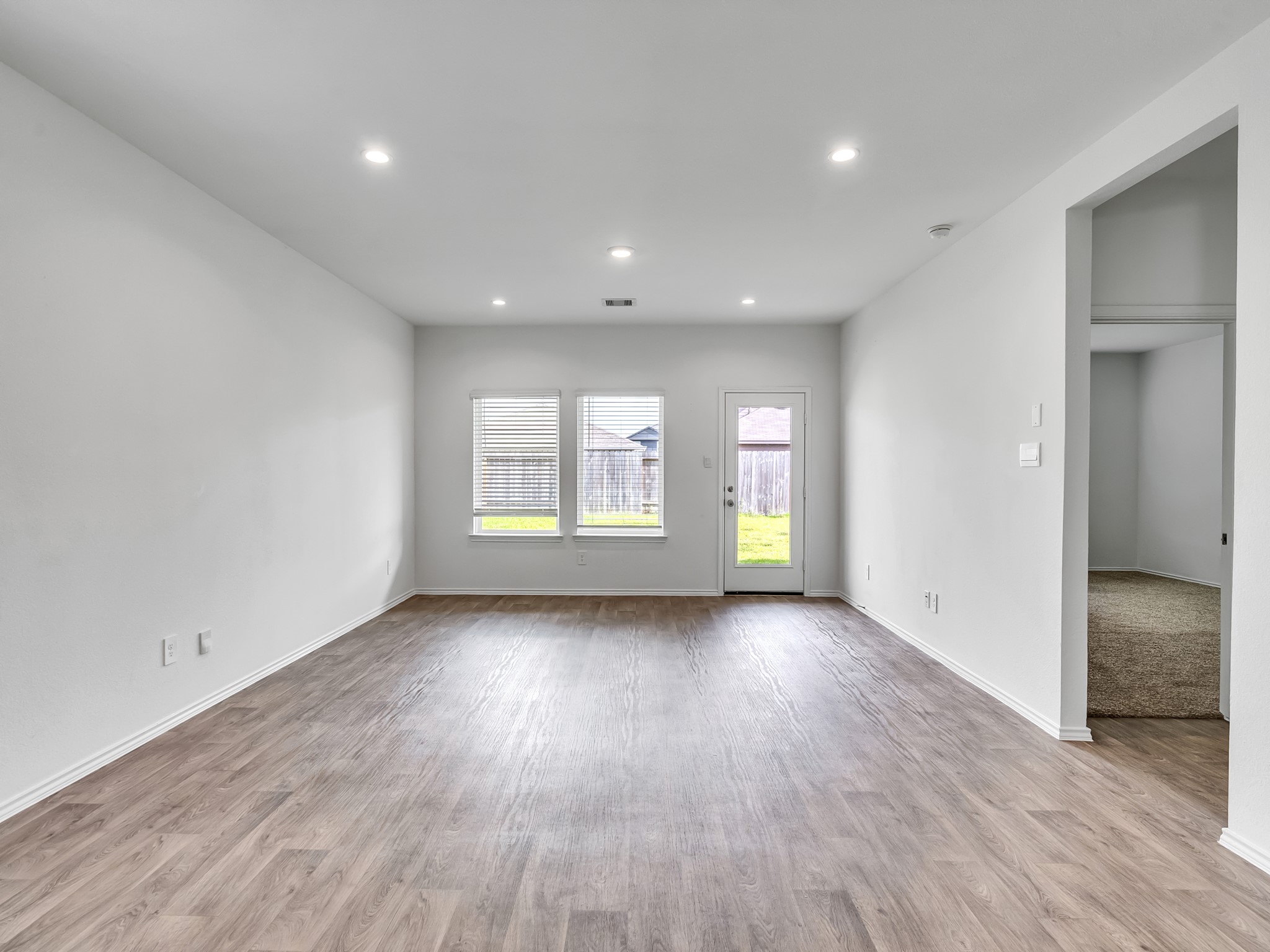 5431 Tuscany Hills Lane Spring, TX 77373 - Photo 19 of 22 an empty room with wooden floor and windows