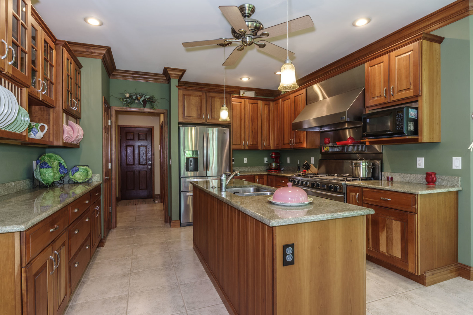 21221 Hidden Valley Loop Lexington, IL 61753 - Photo 16 of 44 a kitchen with stainless steel appliances granite countertop a sink and cabinets