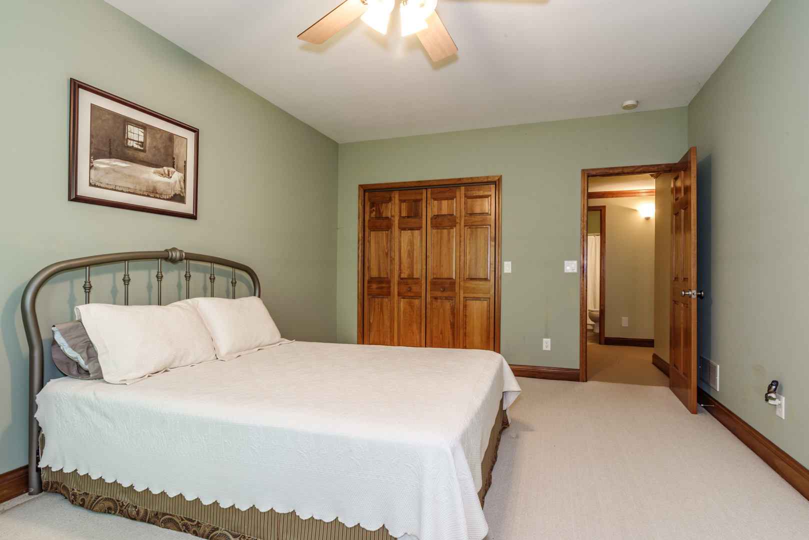 21221 Hidden Valley Loop Lexington, IL 61753 - Photo 40 of 44 a bedroom with a large bed and a chandelier