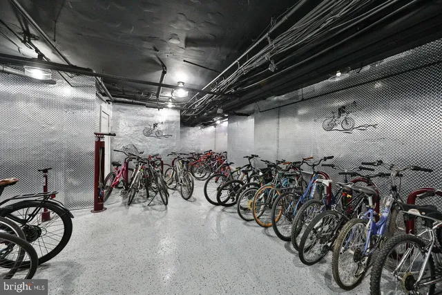 a hallway with wooden floor washer and dryer