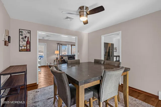 a view of a dining room with a table and chairs