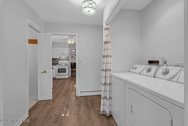 a view of washer and dryer with wooden floor