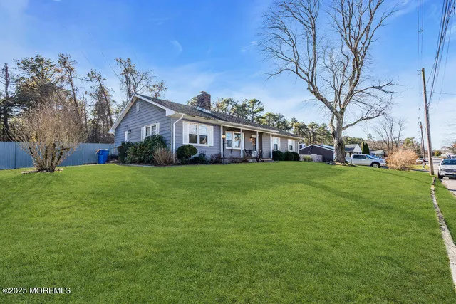 a view of house that has a yard