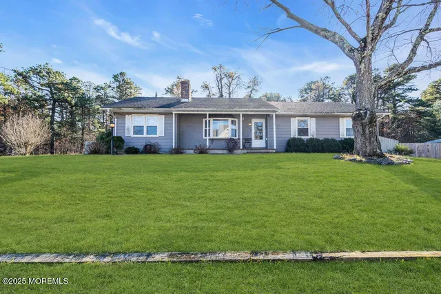 a view of a house with a yard and a fountain