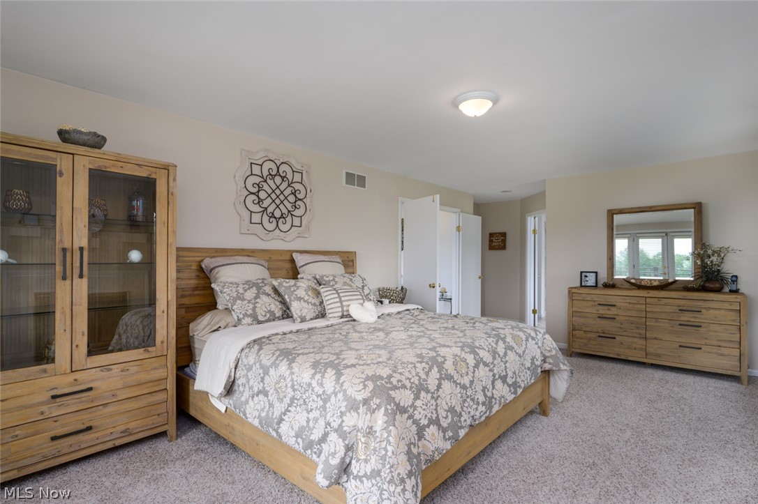 1817 Steffy Road Mogadore, OH 44260 - Photo 34 of 49 Bedroom featuring light carpet, fireplace, and private balcony