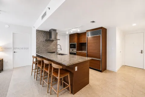 a kitchen with stainless steel appliances granite countertop a stove and a refrigerator