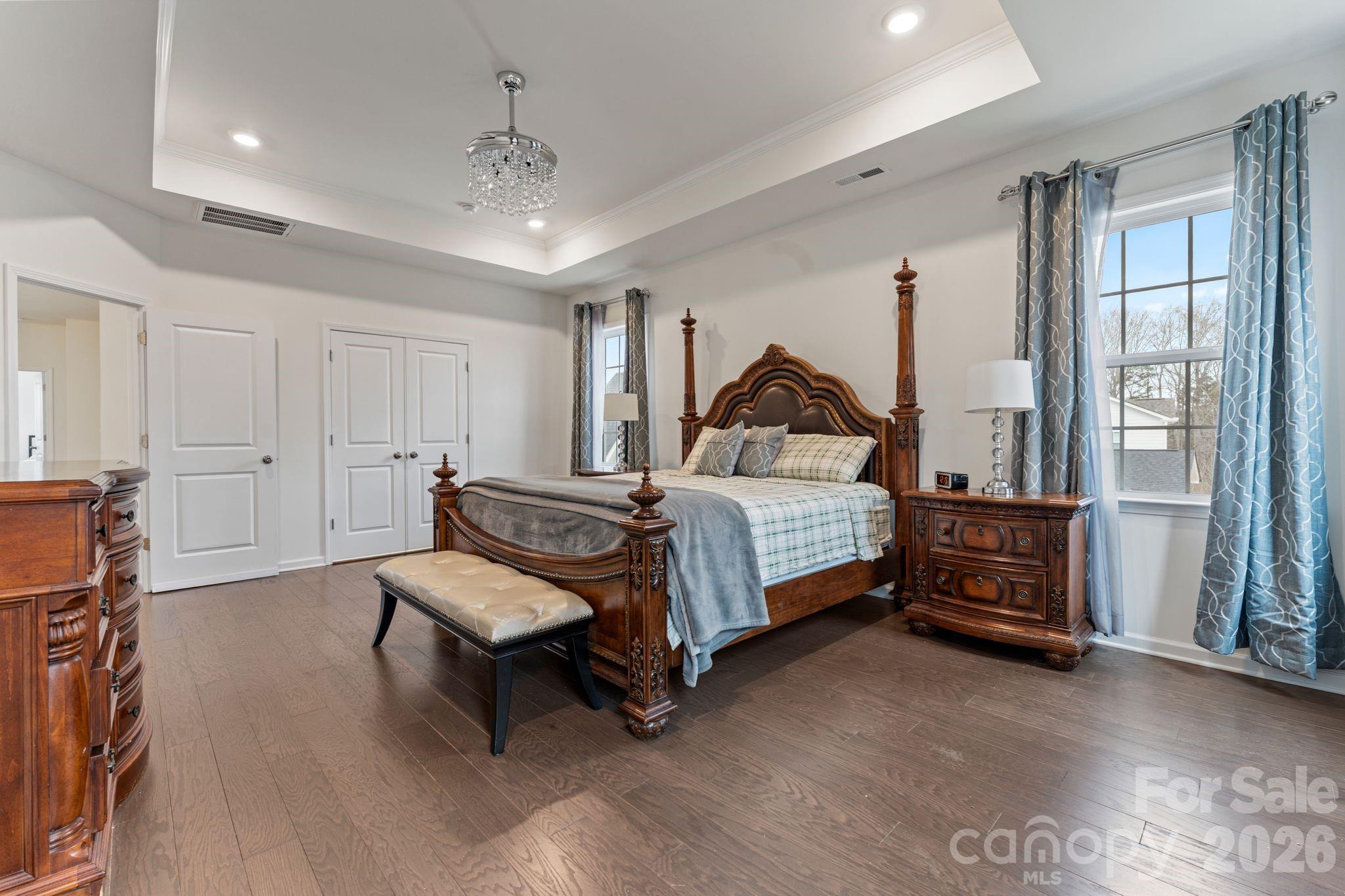 9786 Verdun Court Fort Mill, SC 29707 - Photo 17 of 41 a bedroom with a bed and a chandelier