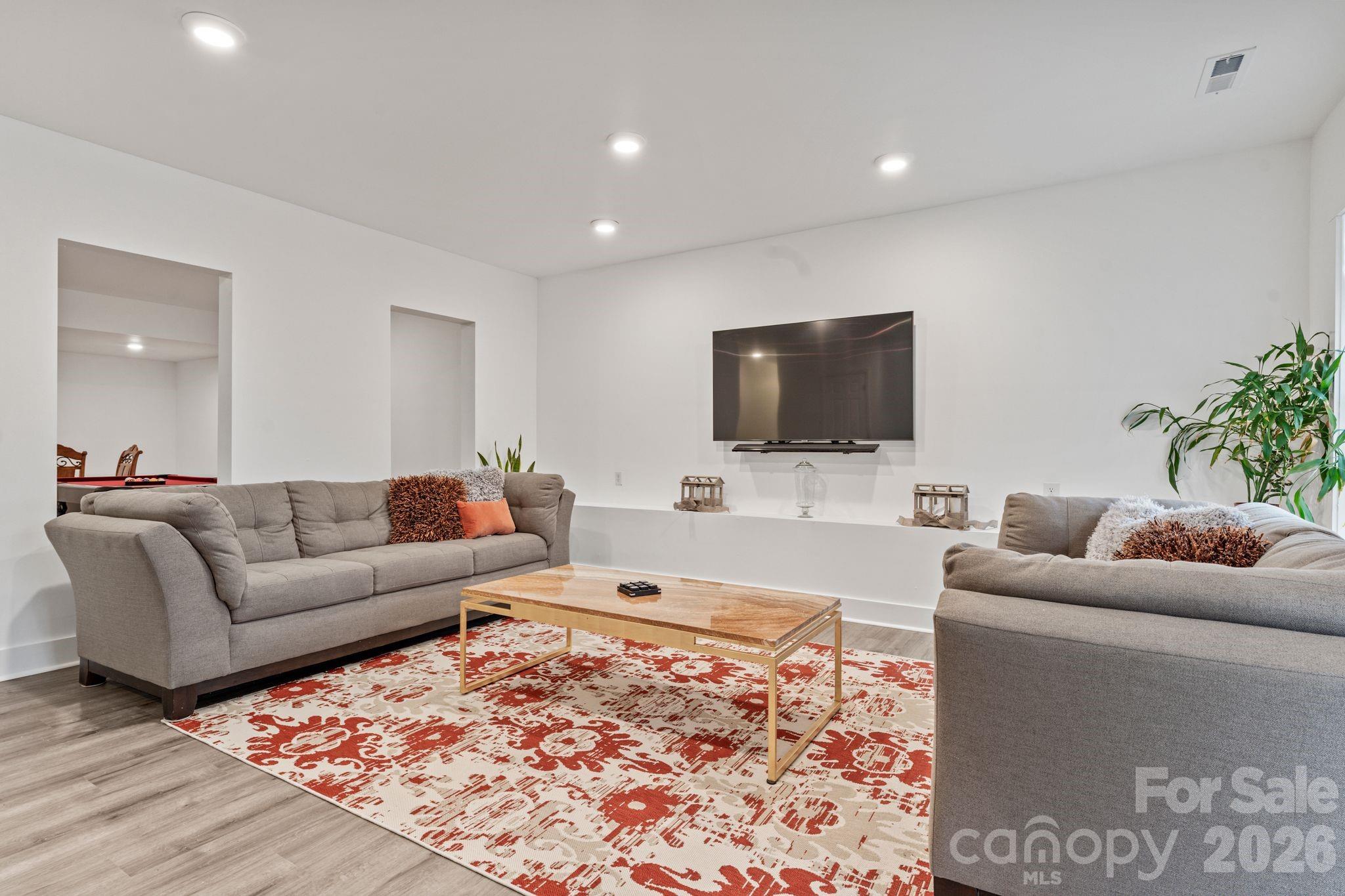 9786 Verdun Court Fort Mill, SC 29707 - Photo 27 of 41 a living room with furniture and a flat screen tv