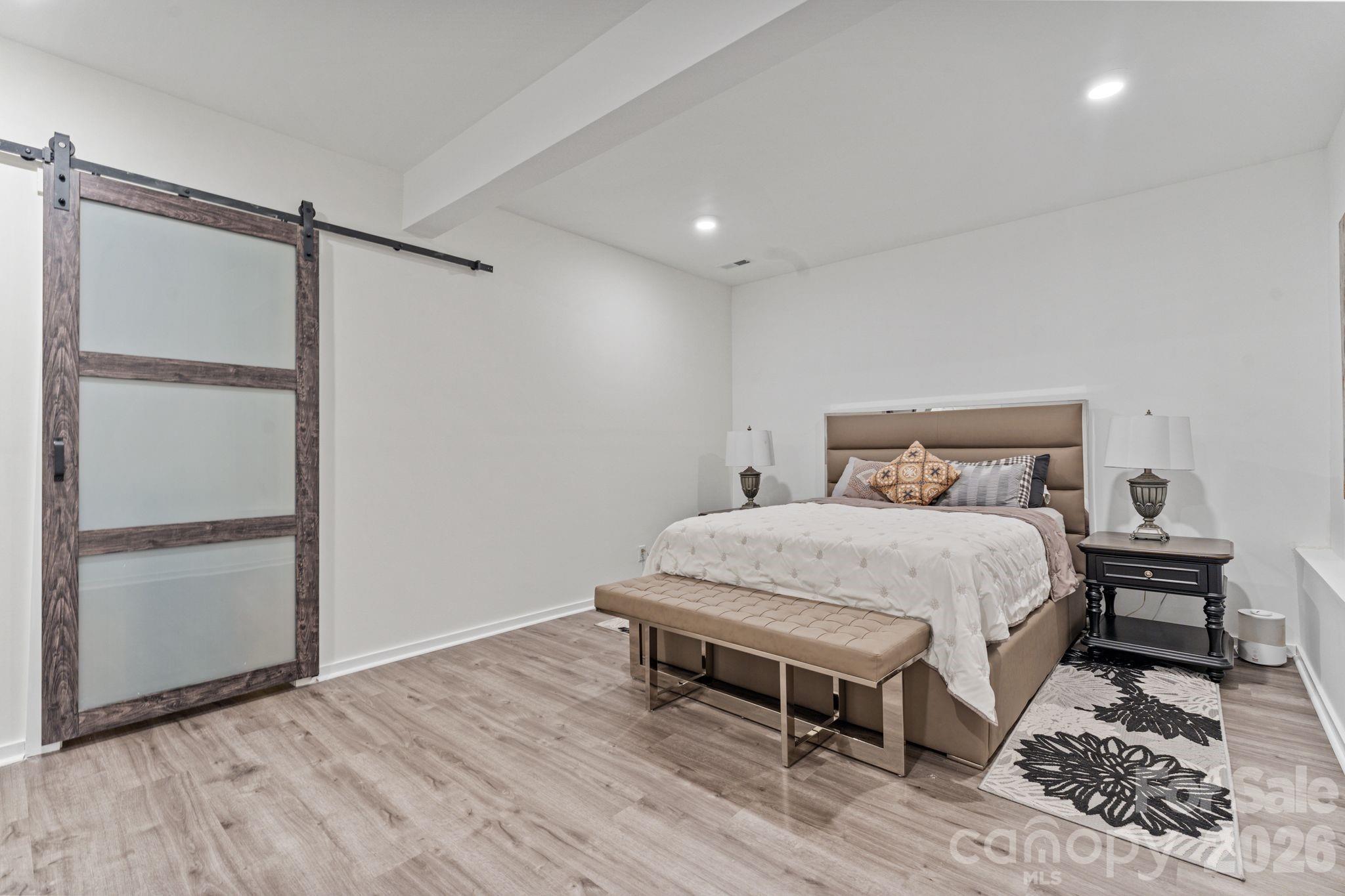 9786 Verdun Court Fort Mill, SC 29707 - Photo 31 of 41 a bedroom with a bed and wooden floor