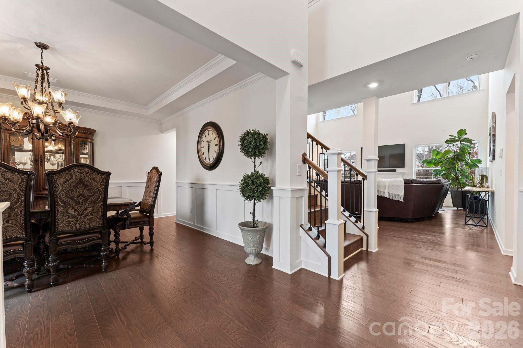 9786 Verdun Court Fort Mill, SC 29707 - Photo 4 of 41 a living room with furniture a chandelier and a dining table with wooden floor