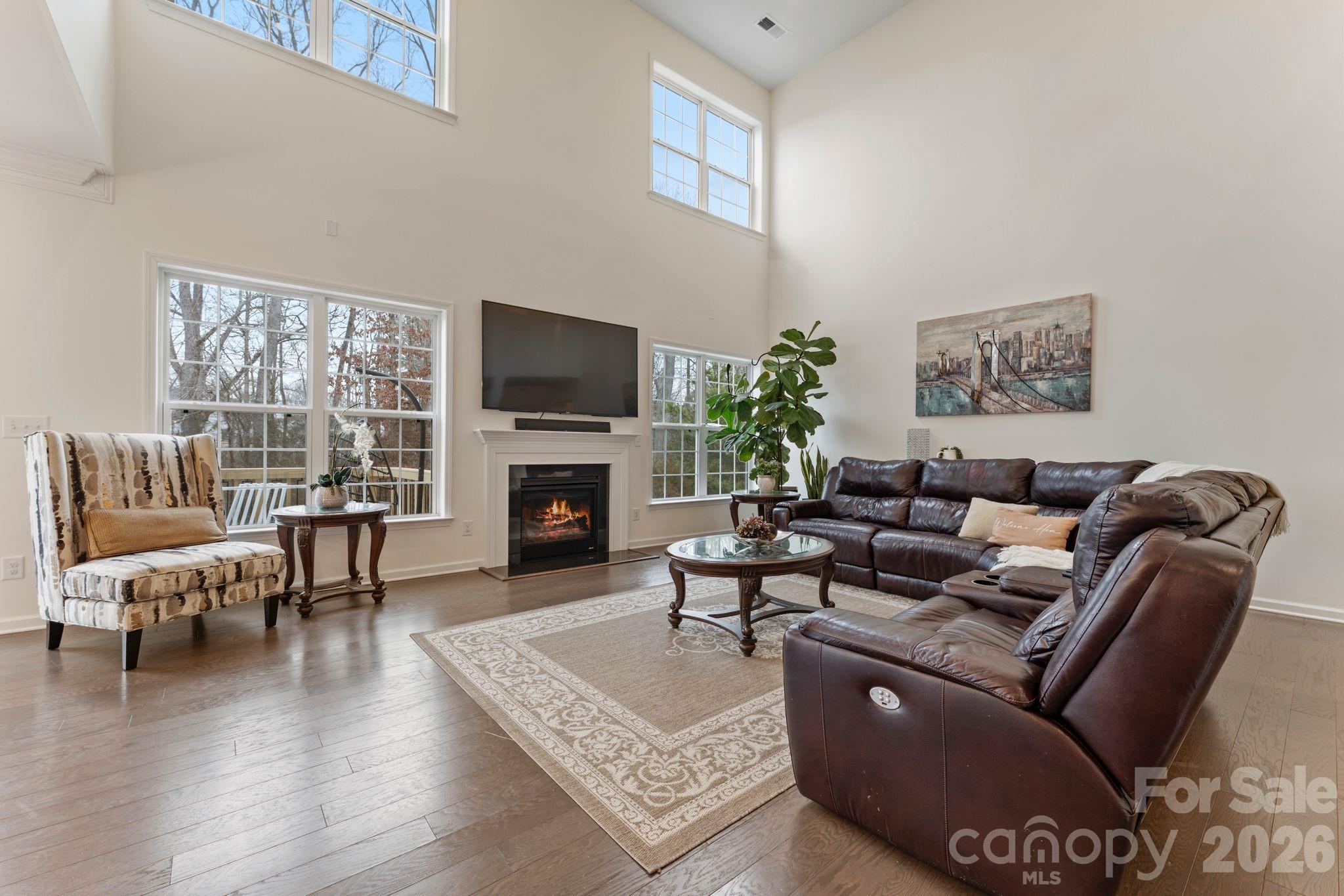 9786 Verdun Court Fort Mill, SC 29707 - Photo 7 of 41 a living room with furniture a fireplace a flat screen tv and a large window
