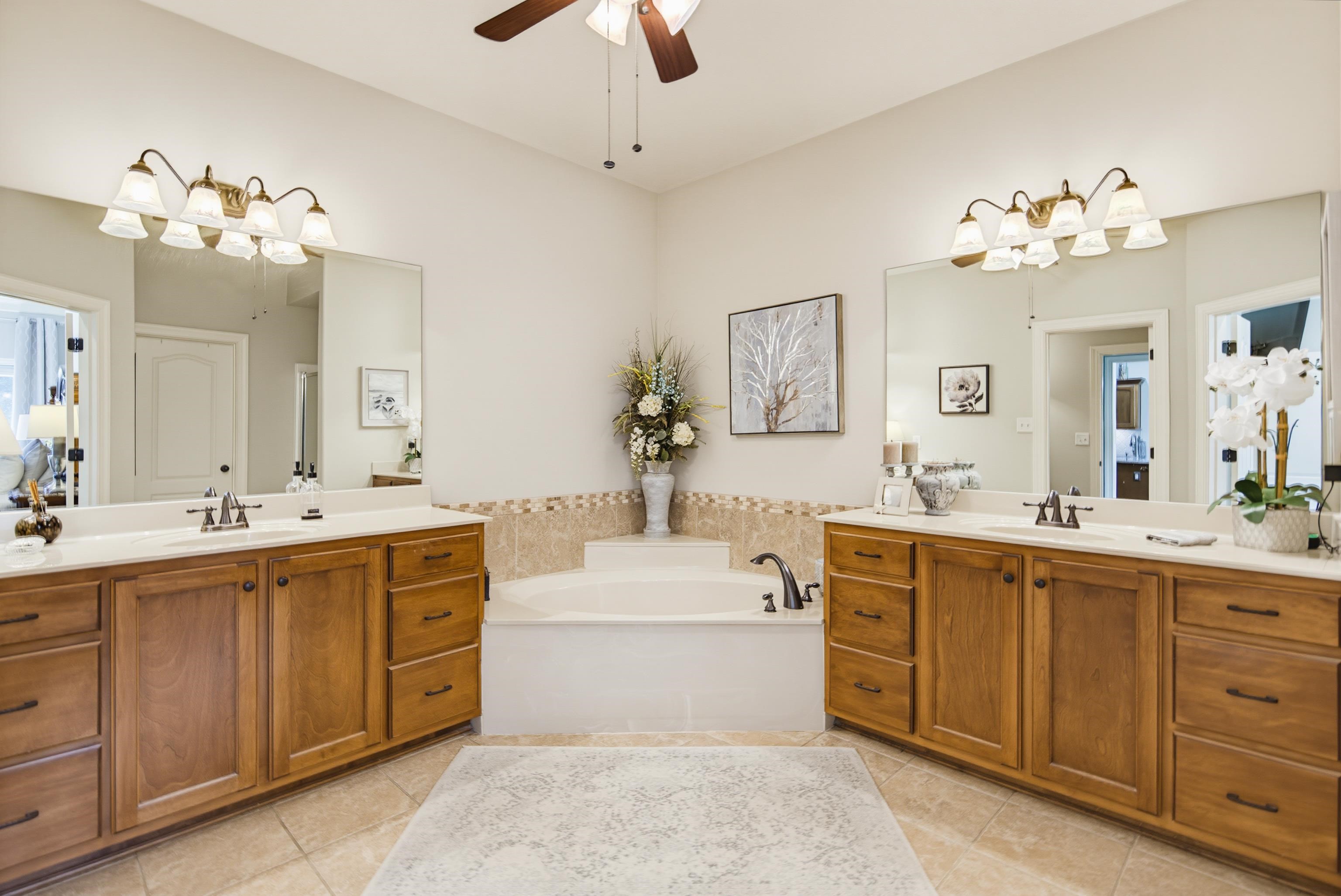 243 Hayes Road Munford, TN 38058 - Photo 14 of 25 Dual vanities with integrated sinks, each featuring oil rubbed bronze faucets and fixtures with expansive mirrors and deep tub.