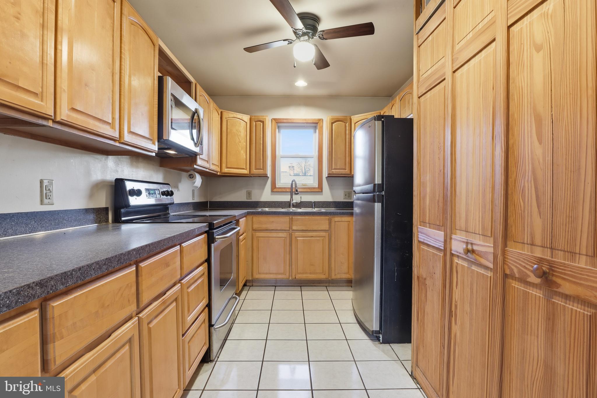 1330 Goodyear Road Gardners, PA 17324 - Photo 47 of 72 a kitchen with stainless steel appliances granite countertop a refrigerator a sink dishwasher and white cabinets with wooden floor