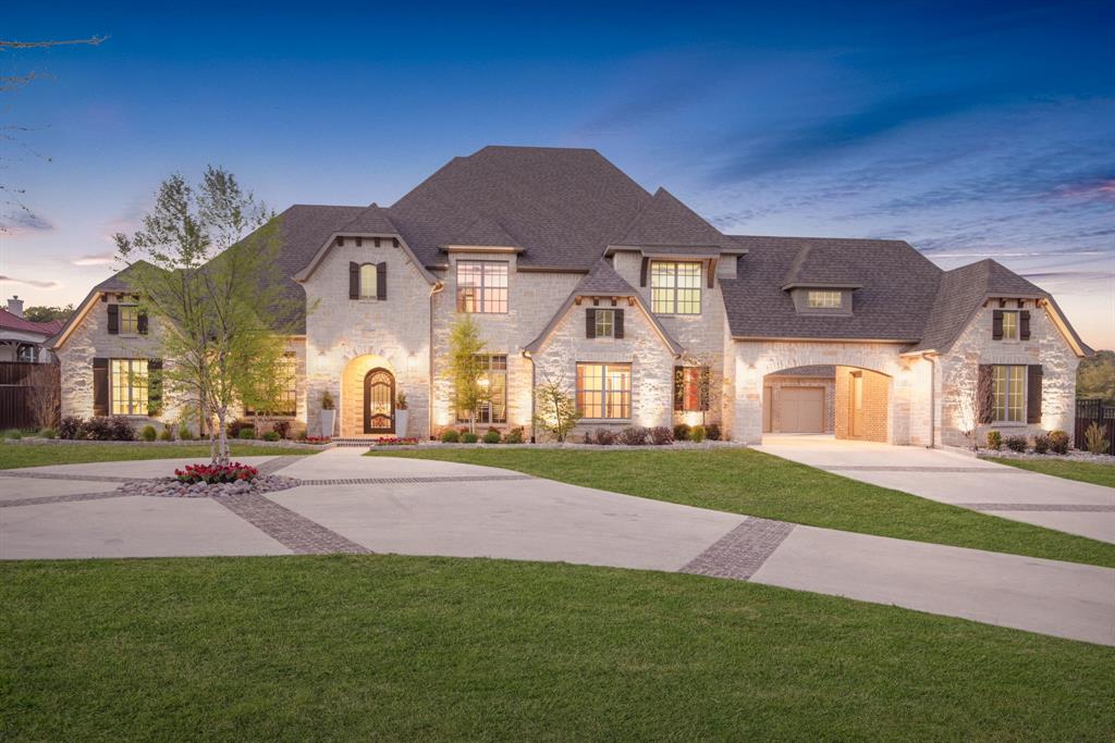 a view of a big house with a big yard and large tree