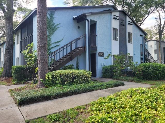 196 Riverbend Drive, Unit 102 Altamonte Springs, FL 32714 - Photo 1 of 18 a front view of a house with garden