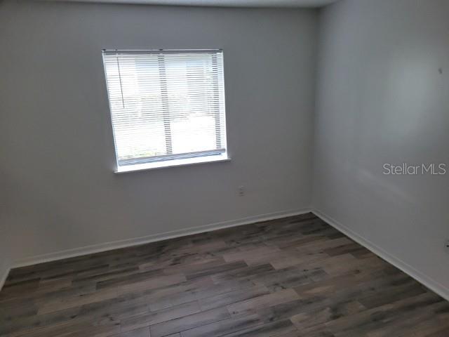 196 Riverbend Drive, Unit 102 Altamonte Springs, FL 32714 - Photo 12 of 18 an empty room with wooden floor and windows