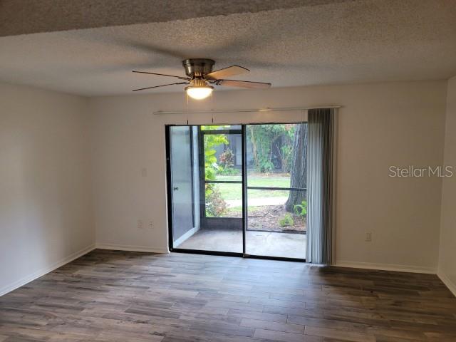 196 Riverbend Drive, Unit 102 Altamonte Springs, FL 32714 - Photo 6 of 18 an empty room with wooden floor and windows