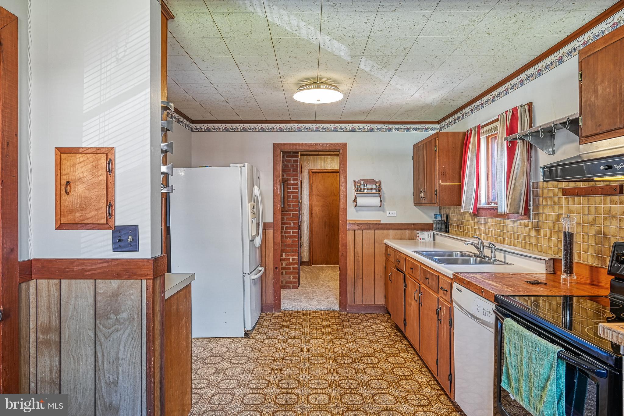 517 Doctors Road Louisa, VA 23093 - Photo 21 of 83 a kitchen with stainless steel appliances granite countertop a refrigerator a stove and a sink with wooden cabinets