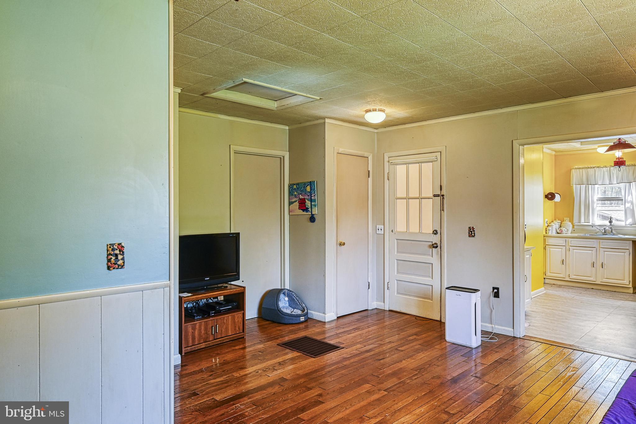 517 Doctors Road Louisa, VA 23093 - Photo 45 of 83 a view of a livingroom with wooden floor and a flat screen tv