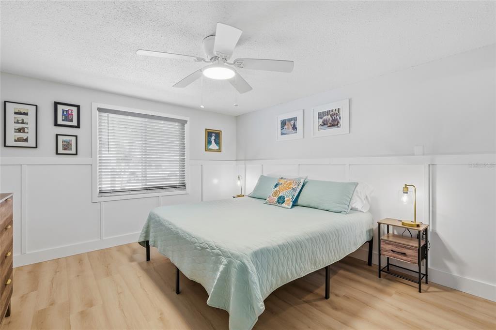 417 63rd Street Holmes Beach, FL 34217 - Photo 13 of 48 a bedroom with a bed and a table