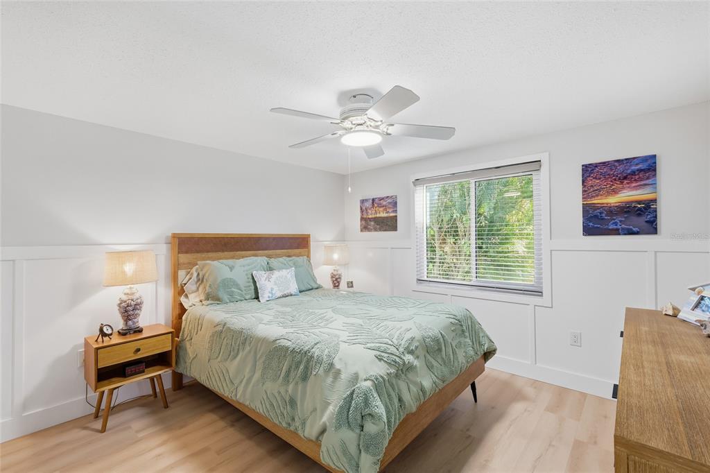 417 63rd Street Holmes Beach, FL 34217 - Photo 15 of 48 a bedroom with a bed and a chandelier