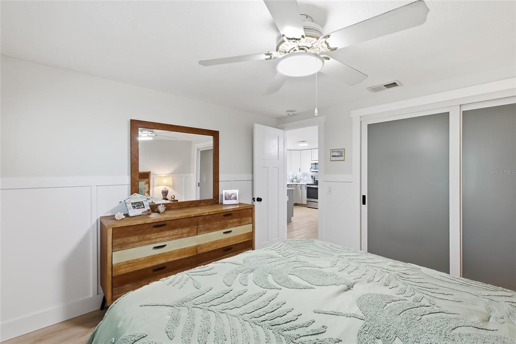 417 63rd Street Holmes Beach, FL 34217 - Photo 16 of 48 a bedroom with a bed and a chandelier