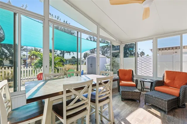 a view of a dining room with furniture water view and wooden floor