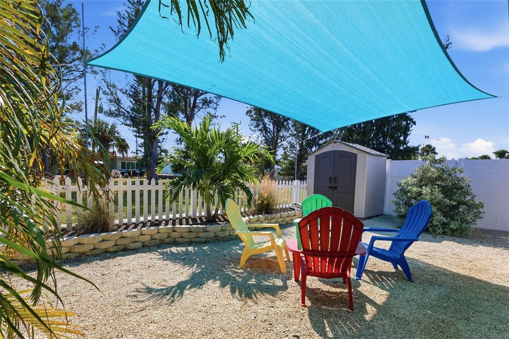 417 63rd Street Holmes Beach, FL 34217 - Photo 21 of 48 a view of a chairs and table in backyard