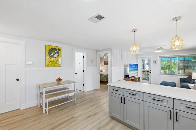 a view of a kitchen with cabinets and wooden floor