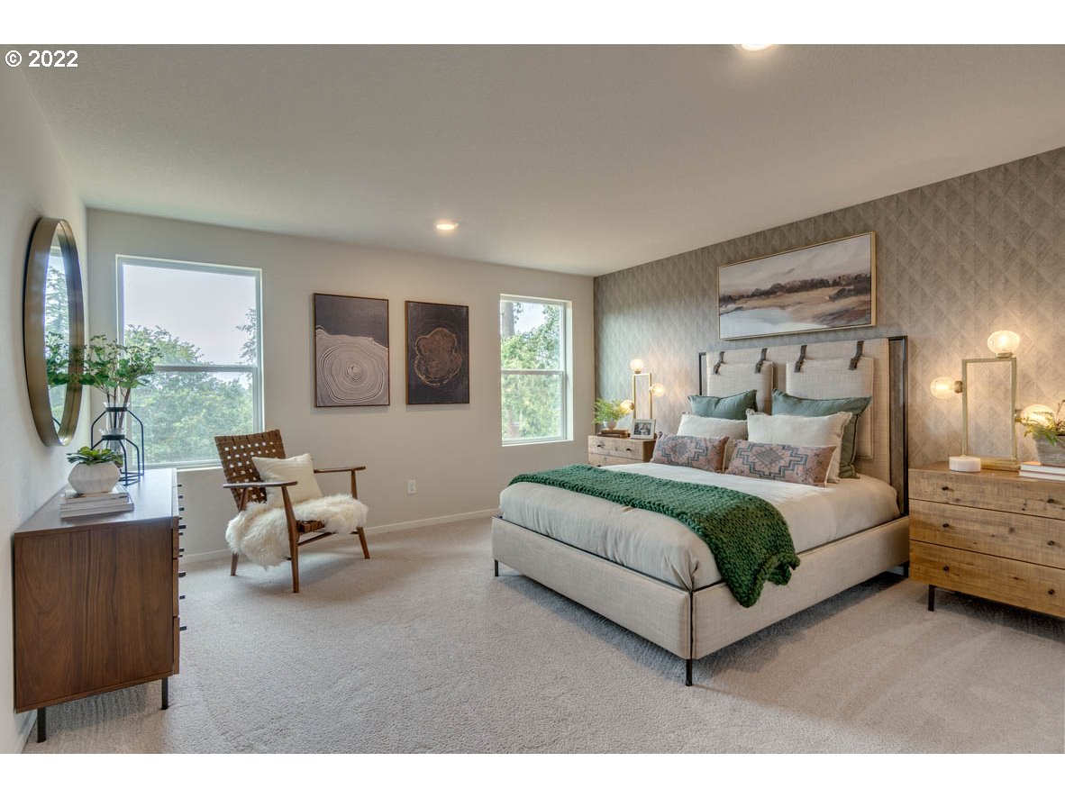 2904 North 3rd Way Ridgefield, WA 98642 - Photo 16 of 24 a spacious bedroom with a large bed and a couch
