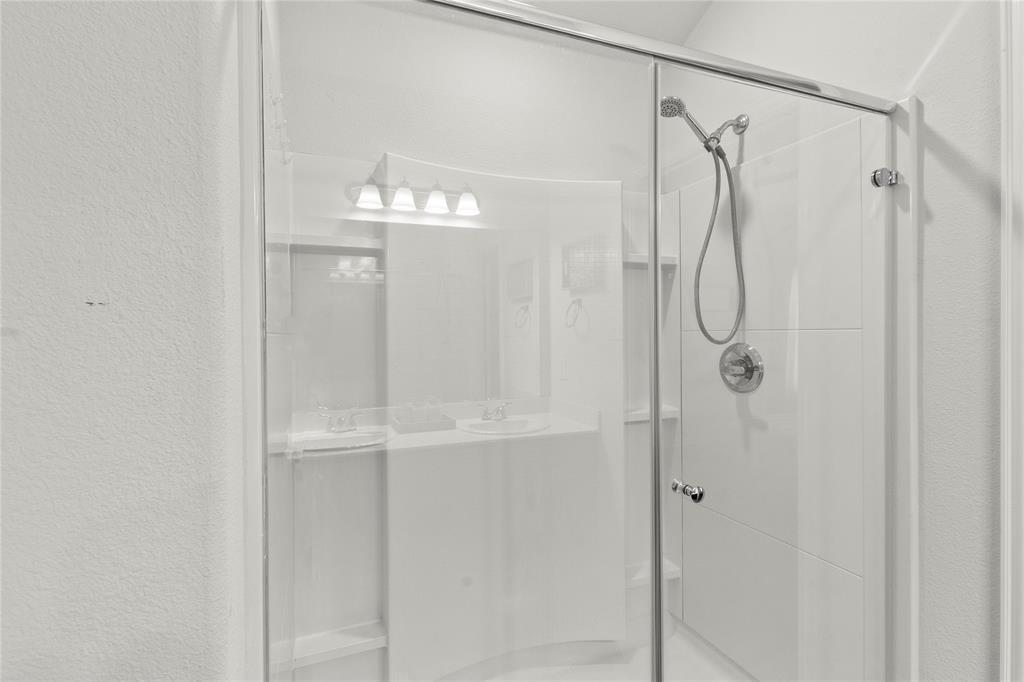 115 Oak Spgs Loop Mabank, TX 75147 - Photo 15 of 20 a bathroom that has a glass shower door