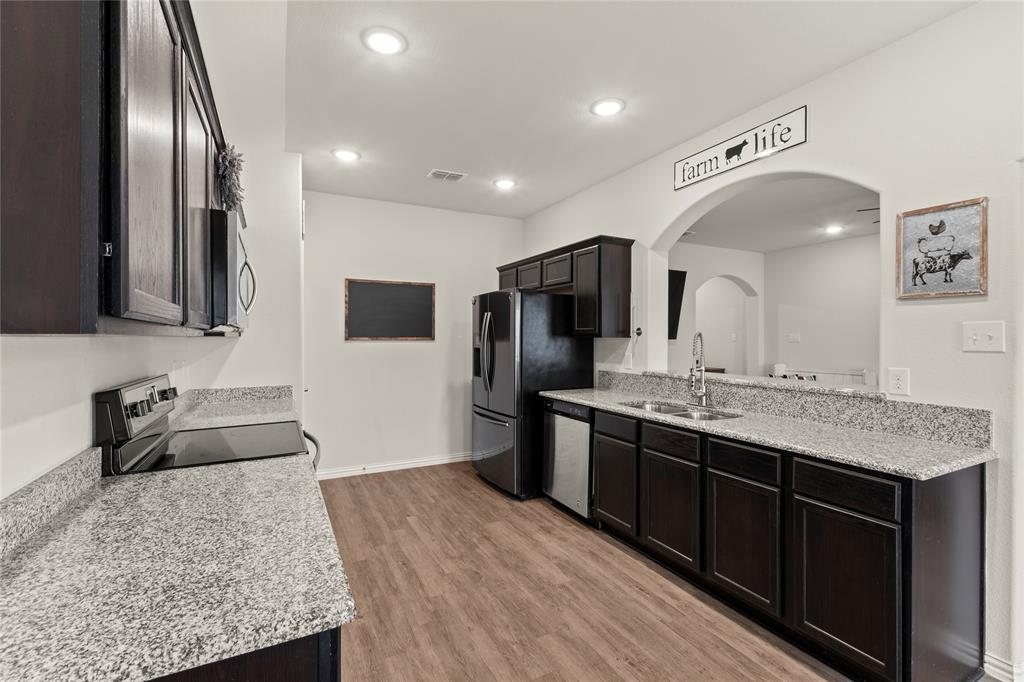 115 Oak Spgs Loop Mabank, TX 75147 - Photo 6 of 20 a large kitchen with stainless steel appliances granite countertop a sink and a stove