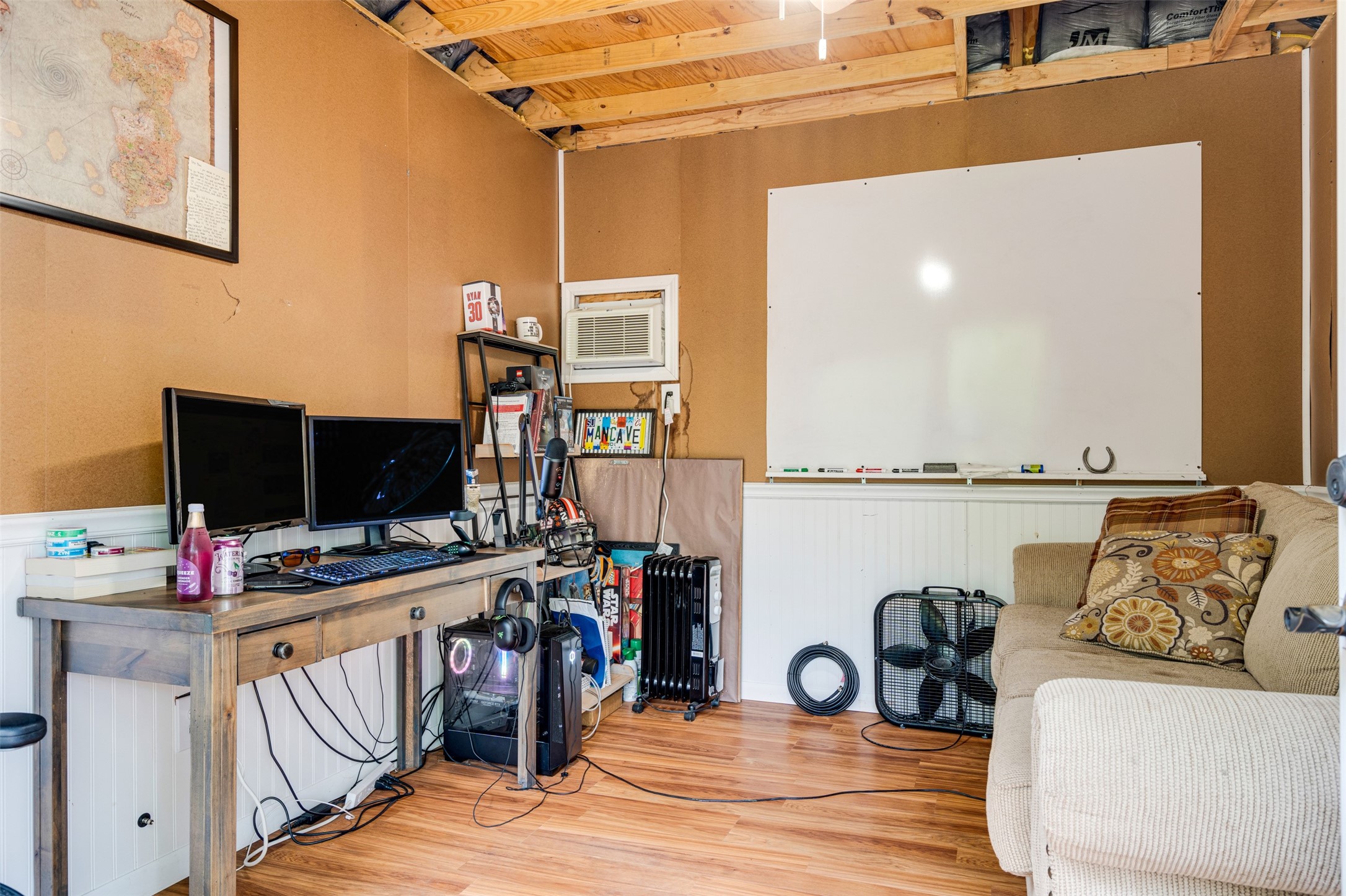 112 Boulder Lane Manor, TX 78653 - Photo 19 of 39 a view of a workspace with furniture and a flat screen tv